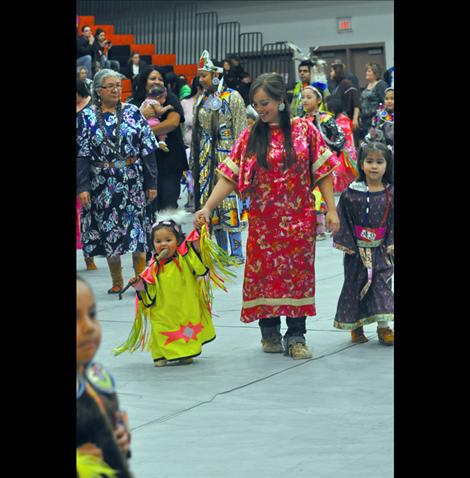 Meanip Plentyhorses chews on a drumstick at the Headstart Powwow in Ronan.