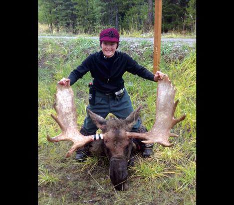 Josey Motichka displays her bull moose. Josey shot the big mammal in the Middle Fork of the Flathead River. 