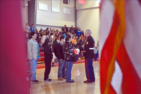 Arlee students listen to a presentation by Sgt. Chuck Lewis about why flags should be respected.