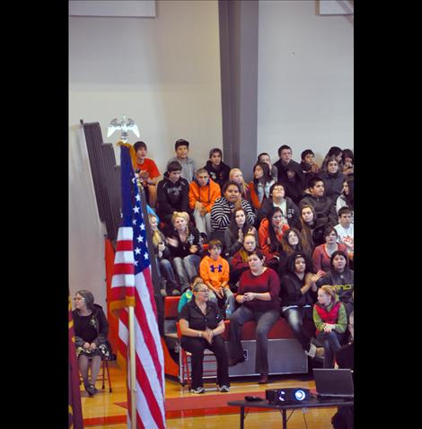 Arlee students listen to a presentation by Sgt. Chuck Lewis about why flags should be respected.