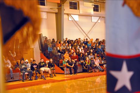 Arlee students listen to a presentation by Sgt. Chuck Lewis about why flags should be respected.