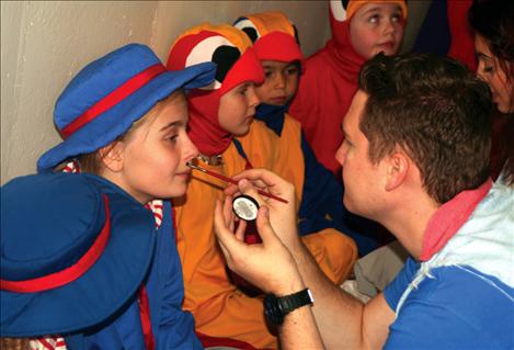 Missoula Children’s Theatre directors Greg Stowers and Coryn Bourgeois applied stage makeup to 60 student actors before the big show.