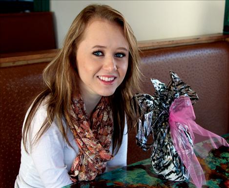 Shelby Benson displays one of the gift baskets she puts together and delivers to nursing homes throughout Lake Country as part of the “Adopt a Grandparent” Program.