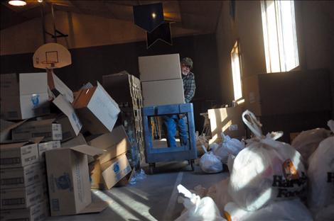 Mack McConnell pushes a cart full of cereal and cheese that will be delivered to the elderly and children in Lake County.