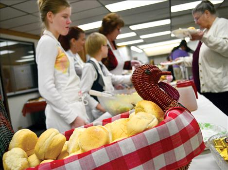 Warm rolls beckon as plates of Thanksgiving fare are served at the Ronan Community Center on Thanksgiving day 2012.