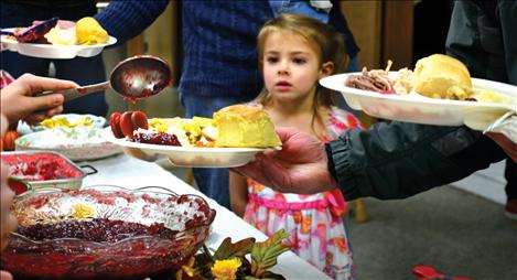 A plate of Thanksgiving dinner is the focus of this young lady at Ronan's 2012 community dinner.