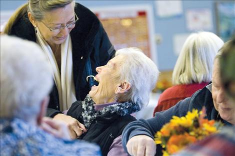 Thanksgiving cheer abounds as friends visit and Pastor John Payne enjoys the food at the Polson Community Thanksgiving Dinner last year. 