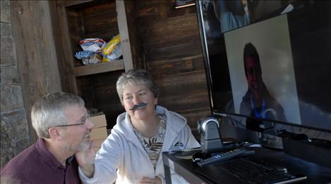 Judge Teresa Van Buren examines David Morton’s beard as a colleague in the Helena Black Mountain Software office also checks out Morton’s facial hair.