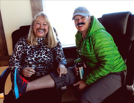 Kim Namen draws black stubble on Melissa Chowning’s leg before the judging for the Movember prizes at Black Mountain Software.