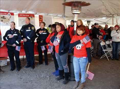 Berl Tiskus/Valley Journal Homes for Our Troops staffers face the flag as the colors are presented.