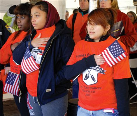 Berl Tiskus/Valley Journal Homes for Our Troops staffers face the flag as the colors are presented.