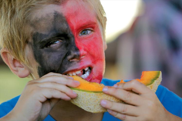 Stephen Ioli, a 7-year-old Dixon resident, chows down on a slice of Dixon melon during the melon-eating contest at Saturday’s Dixon Melon Days.