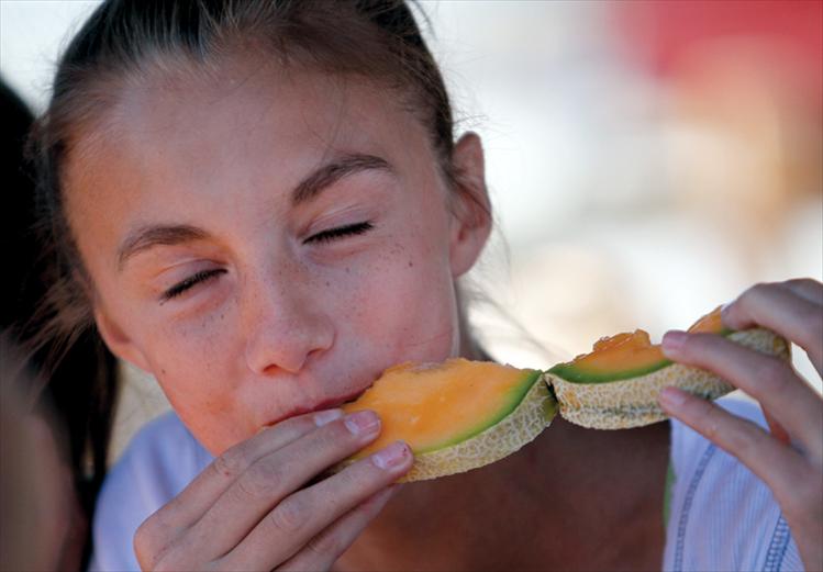 A Dixon melon is a slice of heaven for one young competitor in the melon-eating race.