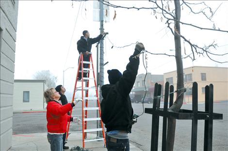 Kicking Horse Job Corps students help hang Christmas lights on Main Street in Ronan.