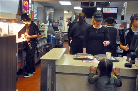 K. William Harvey teacher Whitney DuMont teases one of her students as she waits for food during a McDonald’s fundraiser.  