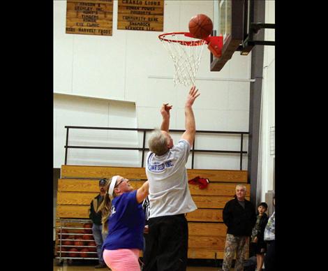 Marcy Gerdts tries to stop Stan Delaney from making a basket.