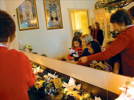 Val Valiquette counts angels among the ornaments with Olivia Jore, right, Samantha Rensvold, Katelyne Druyvestein, and Katelyn Smith at a birthday party for Jesus on Dec. 7. 