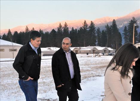 Congressman Steve Daines and SKC Student Life Director Juan Perez walk across the campus as a sunset illumninates the Mission Mountains. 
