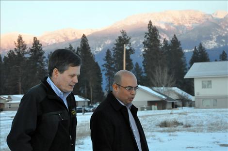 Congressman Steve Daines and SKC Student Life Director Juan Perez walk across the campus as a sunset illumninates the Mission Mountains. 