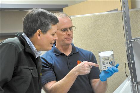 SKC Science Deparment Chair Tim Olson shows Congressman Steve Daines part of a cube satellite NASA will launch in Dec. 2014.  