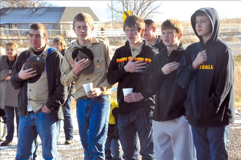 Friends and fellow Boy Scouts of Ryan Fullerton watch as the first flag flies from Fullerton’s Eagle Scout project. 