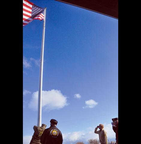 Members of the Veteran's Honor Guard help new Eagle Scout Ryan Fullerton raise the first flag to fly on a flagpole in front of the Charlo-Moiese Fire Department. The flagpole was erected as part of Fullerton’s Eagle Scout project.