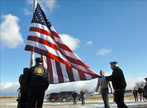 Members of the Veteran's Honor Guard help new Eagle Scout Ryan Fullerton raise the first flag to fly on a flagpole in front of the Charlo-Moiese Fire Department. The flagpole was erected as part of Fullerton’s Eagle Scout project.