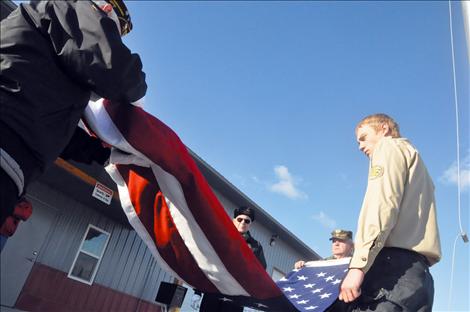 Members of the Veteran's Honor Guard help new Eagle Scout Ryan Fullerton raise the first flag to fly on a flagpole in front of the Charlo-Moiese Fire Department. The flagpole was erected as part of Fullerton’s Eagle Scout project.