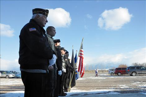 Members of the Veteran's Honor Guard help new Eagle Scout Ryan Fullerton raise the first flag to fly on a flagpole in front of the Charlo-Moiese Fire Department. The flagpole was erected as part of Fullerton’s Eagle Scout project.