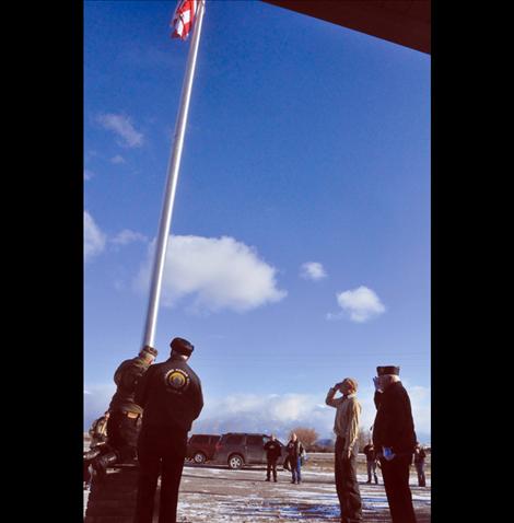 Members of the Veteran's Honor Guard help new Eagle Scout Ryan Fullerton raise the first flag to fly on a flagpole in front of the Charlo-Moiese Fire Department. The flagpole was erected as part of Fullerton’s Eagle Scout project.