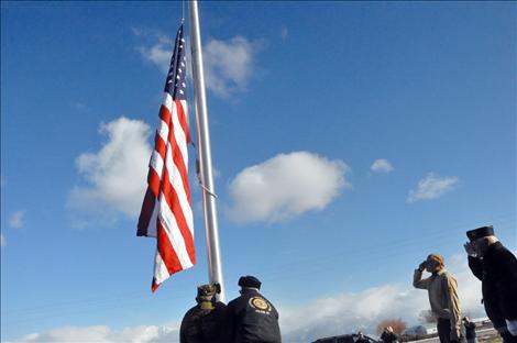 Members of the Veteran's Honor Guard help new Eagle Scout Ryan Fullerton raise the first flag to fly on a flagpole in front of the Charlo-Moiese Fire Department. The flagpole was erected as part of Fullerton’s Eagle Scout project.