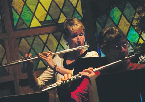 Flutist Margery Christensen, back, plays during the concert. Christensen is part of the Flathead Flute Choir. 