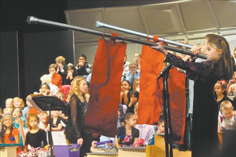 Nichole Koehler, Aaliyah Christensen, and Cayden LaRance  trumpet the  arrival of Good King Wenceslas in  K. William Harvey Elementary School’s Christmas Carol-Along.  