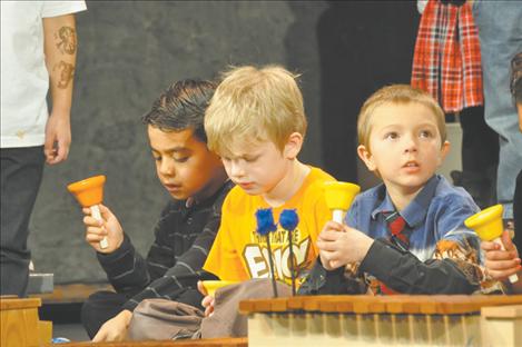 Students read music and follow instructions of teacher Tammy Krahn to know when to shake their bells in the Christmas Carol-Along. 