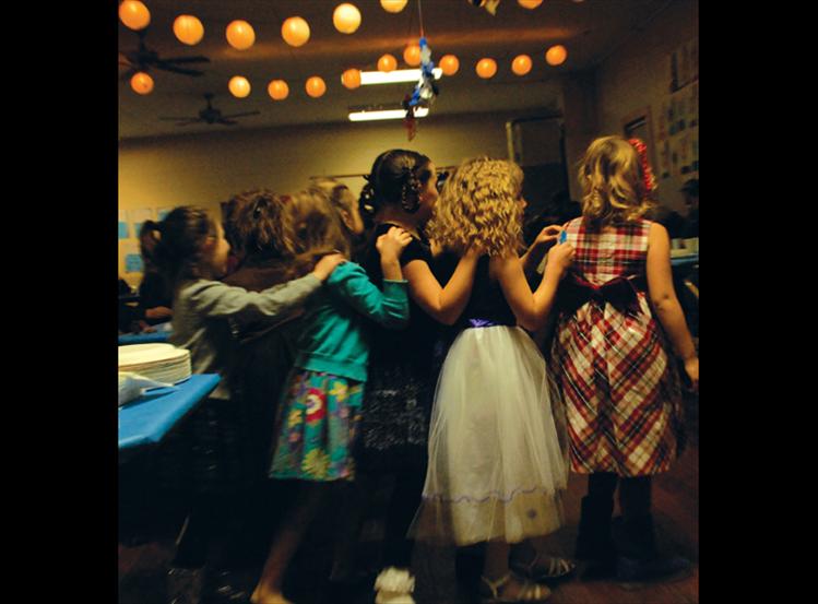 Dressed in their holiday attire, girls at Valley View wait for the Christmas program to get underway.