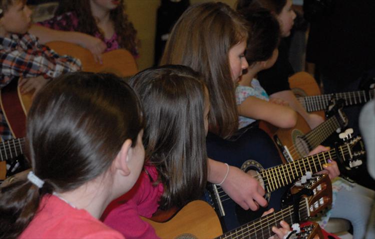 Valley View students play their guitars for parents, family and friends at the Christmas program on Dec. 19.