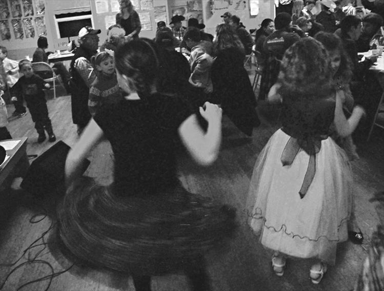 Valley View students engage in some skirt twirling, called for by new Christmas dresses, and play time before the holiday program begins.