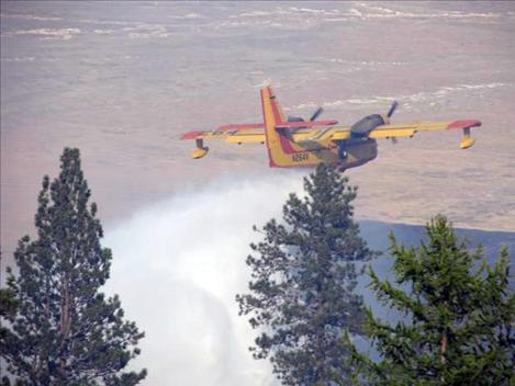 A CL 215 scooper plane dumps water on the West Garcon fire.