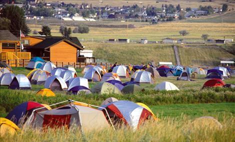 Firefighters sleep in a tent city at the Polson Fairgrounds.