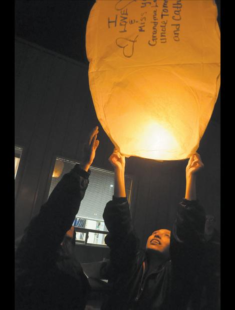 Patricia McCrea and Angel Malatare launch a remembrance lantern.