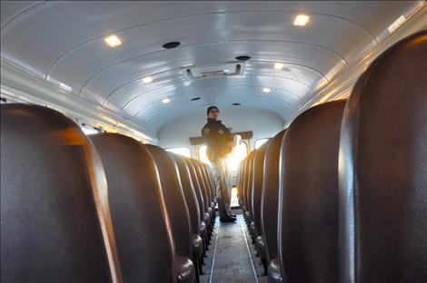 Montana Highway Patrol Trooper Shad Andersen inspects the Ronan fleet of school buses.