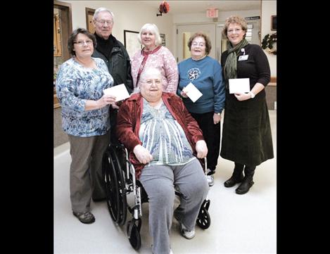 Council on Aging representatives, above from left, include Joann Shaw, Al Sampson and Jan Schmidt; Sherry McDonald with the Bread Basket; and, Jody Thole, supervisor of Lake County Home Health and Hospice. Seated is Janet Rodda, president of the St. Luke Residents’ Council, who presented the checks to the agencies.