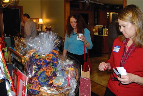 Eva Oruste and Kate Hertz eye Community Spirit Baskets.