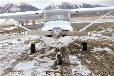 A Cessna 152 that crashed at the St. Ignatius airport on Christmas Eve sits on the runway, awaiting inspection by Federal Aviation Administration investigators.