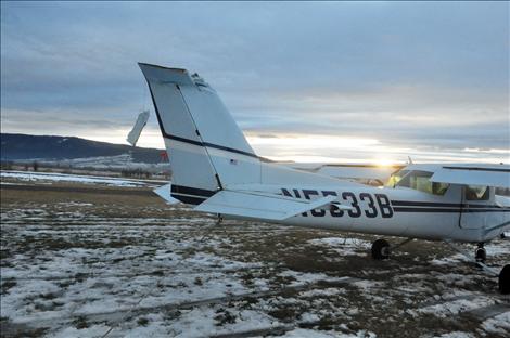 A Cessna 152 that crashed at the St. Ignatius airport on Christmas Eve sits on the runway, awaiting inspection by Federal Aviation Administration investigators.