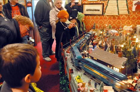 The tiny village captures the attention of youngsters with its Santas, replica cars and railroad signals that lift up and down.