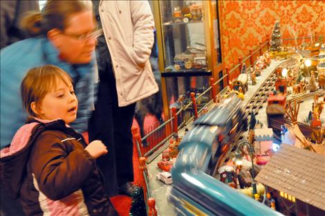 Madison Incashola, 4, is amazed as a model train zooms past in a blur. 