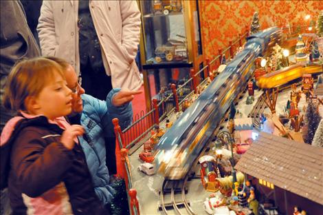 Madison Incashola, 4, is amazed as a model train zooms past in a blur. 