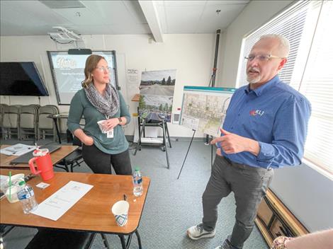 Ronan Reviatlization Chair Whitney Liegakos and Gary Johnson of KLJ Engineering talk after the May 21 meeting.