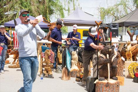A backpacking bear is auctioned Sunday during the final day of the Chainsaw Carving Rendezvous.